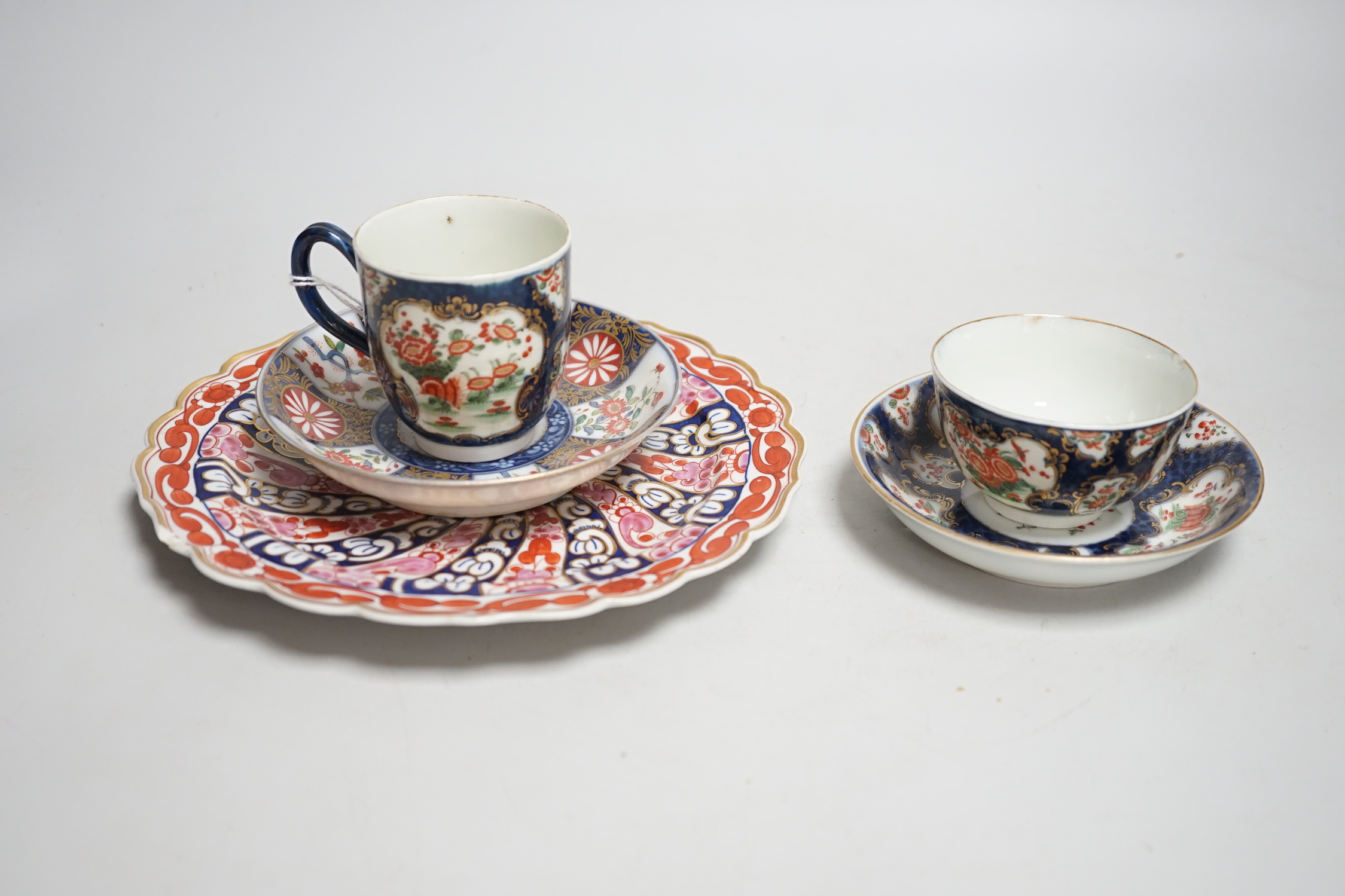 A Worcester kakiemon style scale blue trio, c.1770, a Worcester Queen Charlotte’s pattern plate, 19.5 cm and a Samson saucer in Worcester style